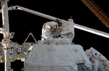 Astronauts Behnken and Patrick remove insulation and bolts from Cupola